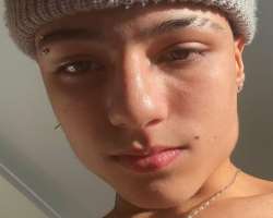 He has piercing in his ears as well as on his eyebrow.